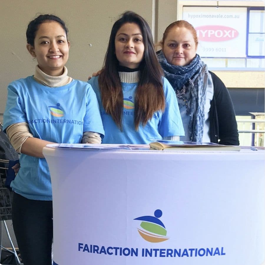 Fairaction volunteers at a community awareness stand