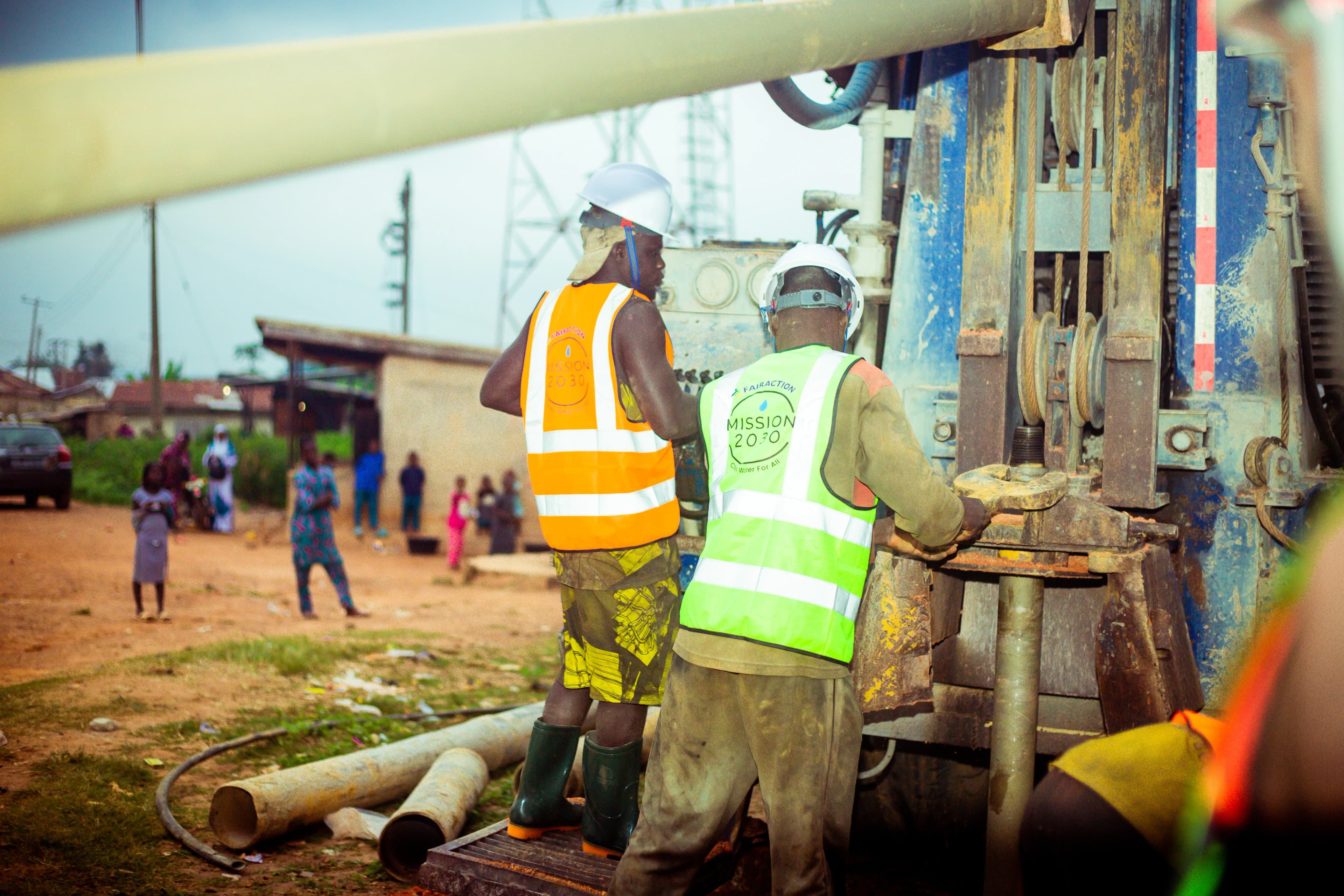 Workers operating a drilling rig to reach groundwater